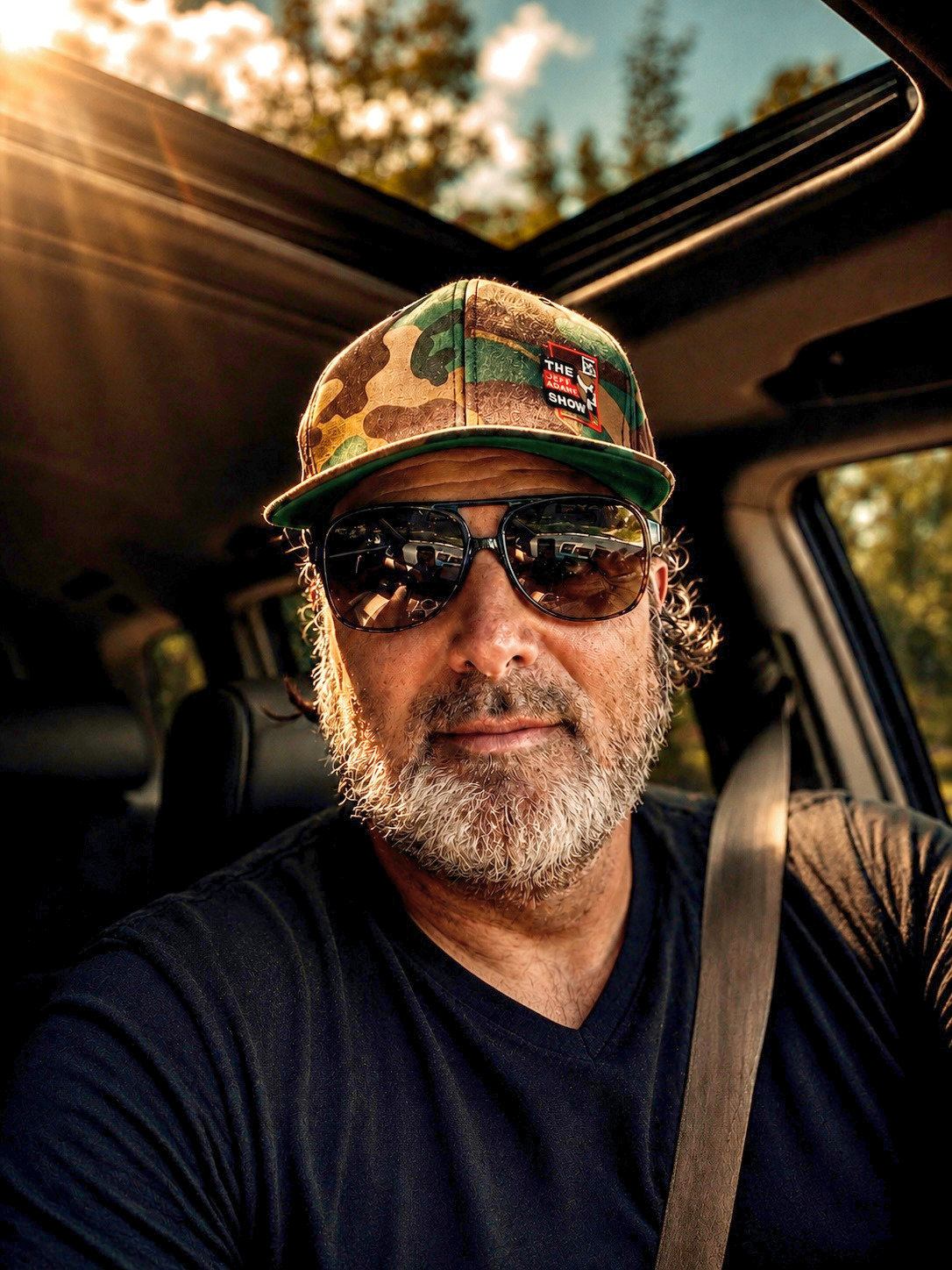 Jeff Adams, creator of Creative on the Mend, in his car with the sunroof open